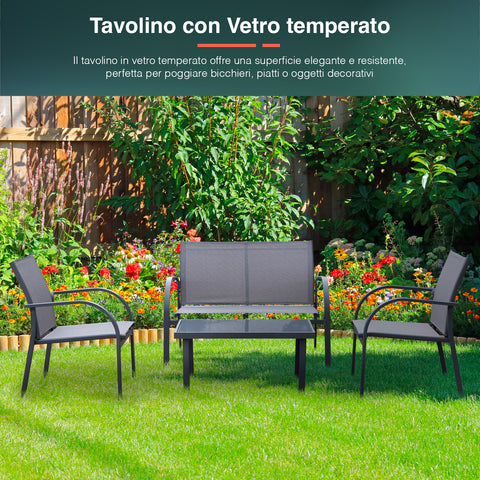Set da giardino con tavolino in vetro temperato - Salotto da esterno elegante con divano e poltrone in textilene grigio posizionato su prato fiorito